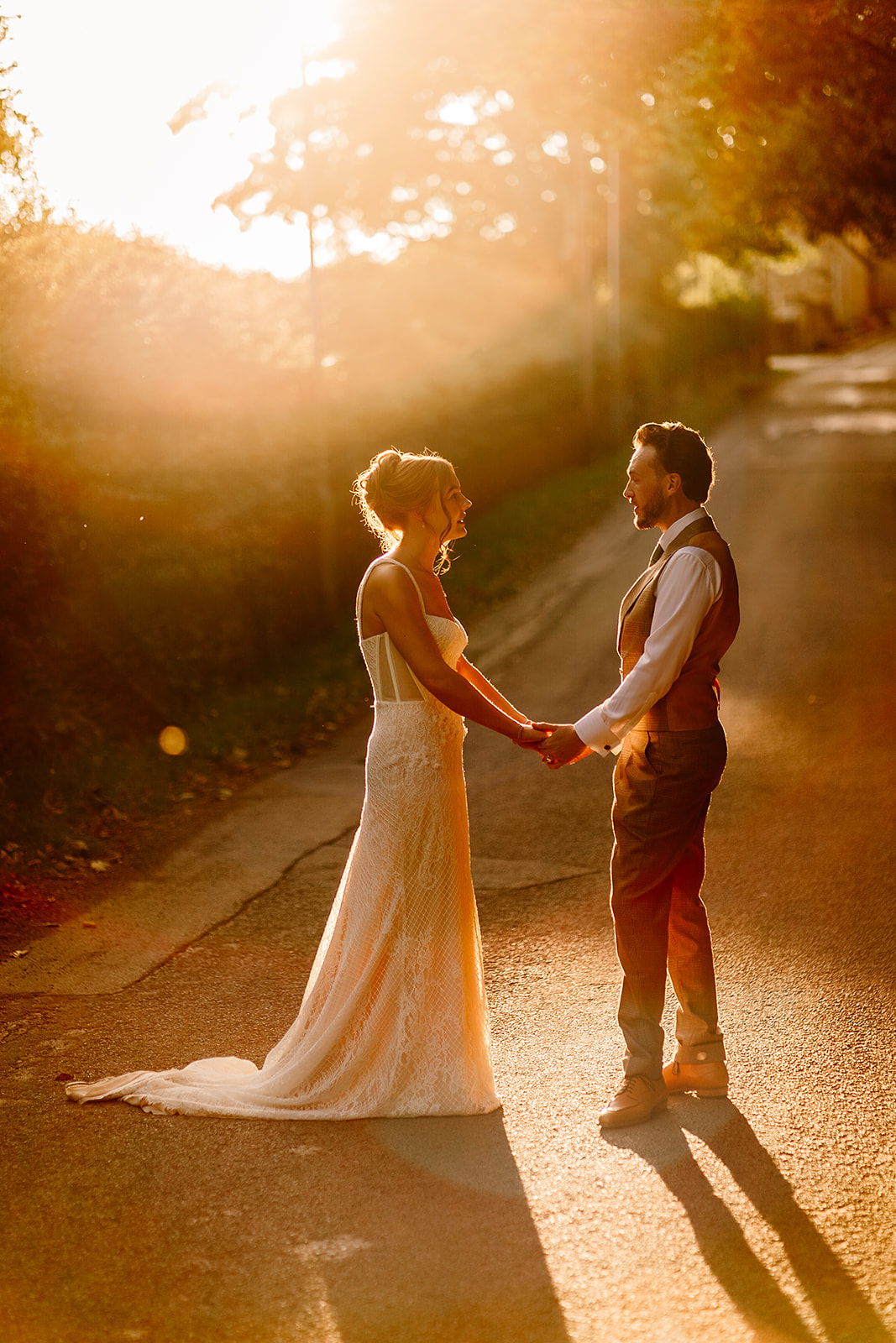 Beth and Kieran enjoying a quiet evening stroll together in the golden light during their Woodman Inn wedding.